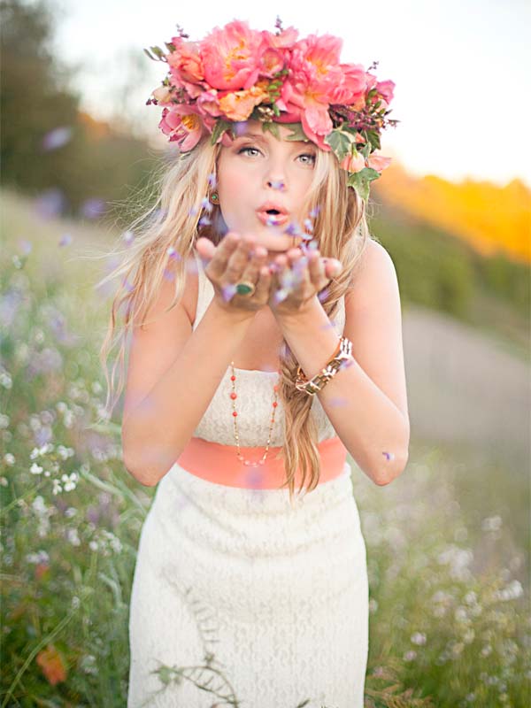 lady with pink flower hat blowing toward the viewer